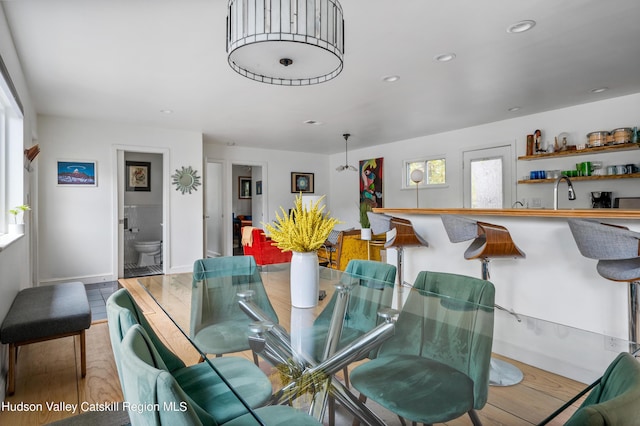 dining area featuring hardwood / wood-style flooring and sink