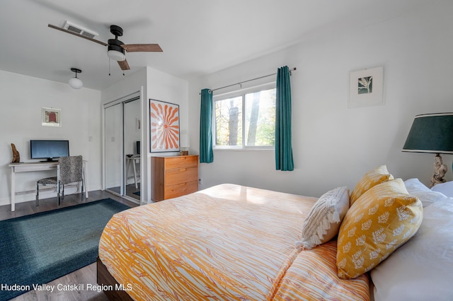 bedroom featuring wood-type flooring, a closet, and ceiling fan