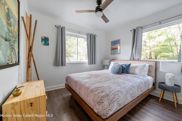 bedroom with ceiling fan and dark hardwood / wood-style floors