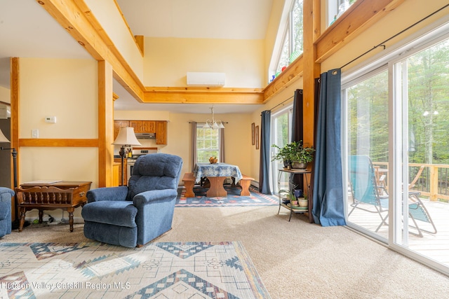 living area featuring carpet flooring, a high ceiling, and an inviting chandelier