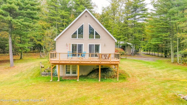 rear view of property featuring a yard and a deck