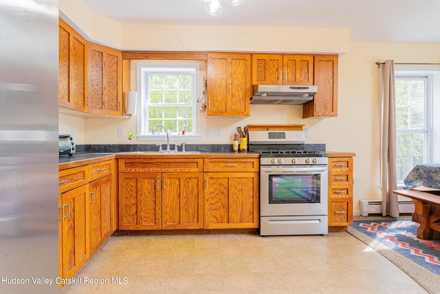 kitchen featuring sink, stainless steel refrigerator, and range with gas stovetop