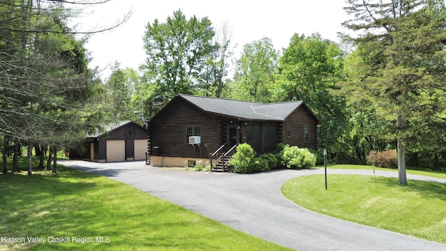 29 Fallen Tree Ln, Athens, NY 12015 - log cabin featuring log exterior, an outbuilding, a detached garage, a front lawn, and curved driveway