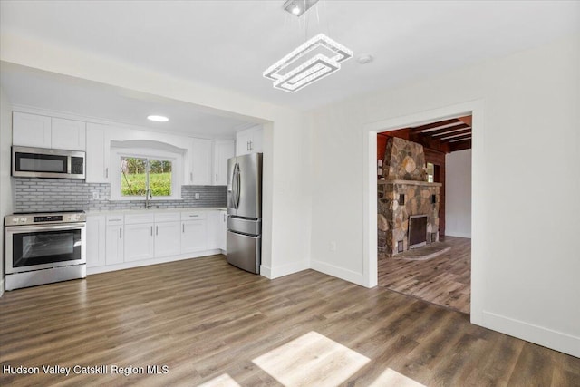 603-607 Old Stage Rd, Saugerties, NY 12477 - kitchen featuring appliances with stainless steel finishes, light countertops, a sink, white cabinetry, and tasteful backsplash
