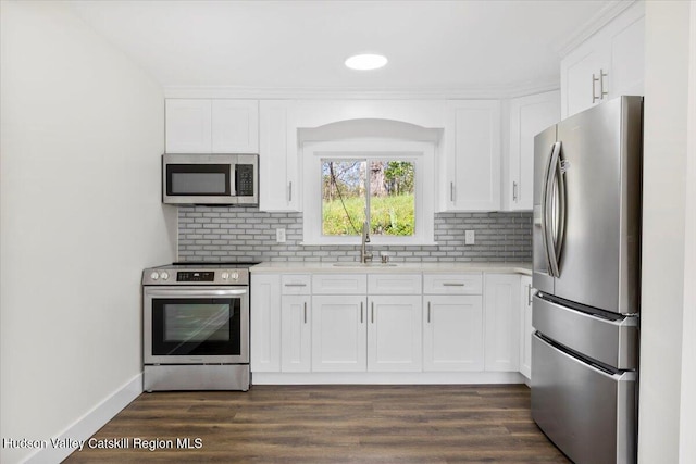 603-607 Old Stage Rd, Saugerties, NY 12477 - kitchen with appliances with stainless steel finishes, light countertops, white cabinetry, tasteful backsplash, and a sink