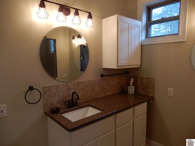 bathroom with tasteful backsplash and vanity