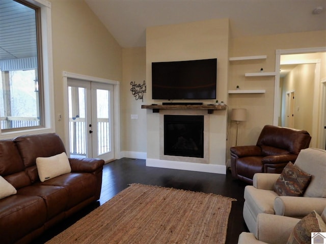 living room with dark hardwood / wood-style flooring, french doors, and lofted ceiling