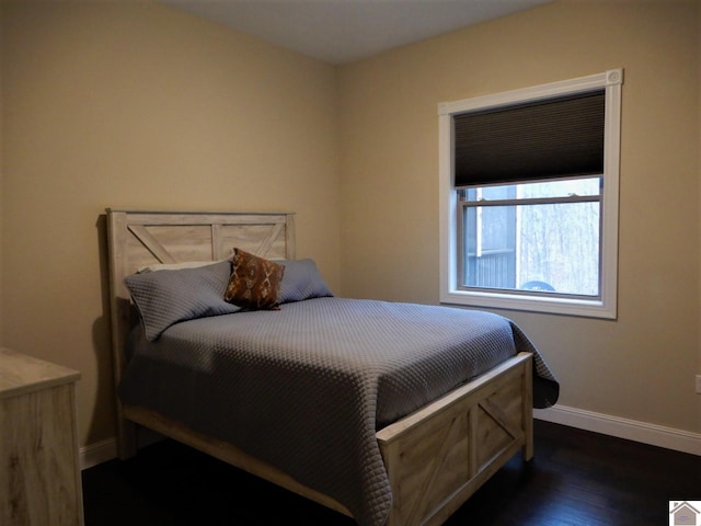 bedroom with dark hardwood / wood-style flooring