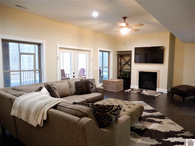 living room with ceiling fan, french doors, and dark hardwood / wood-style flooring