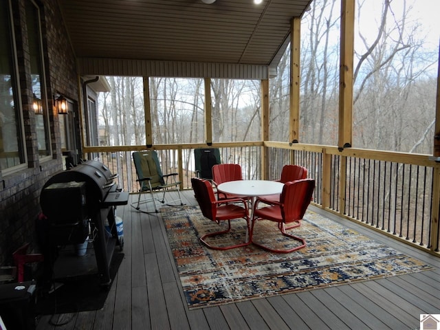 sunroom featuring vaulted ceiling