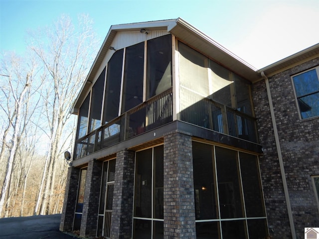 view of side of property featuring a sunroom