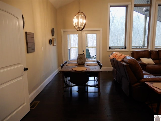 dining area featuring french doors, an inviting chandelier, dark hardwood / wood-style flooring, and a wealth of natural light