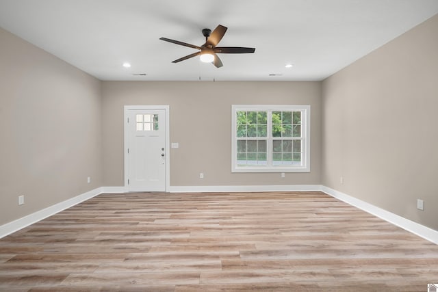 unfurnished room featuring ceiling fan and light wood-type flooring