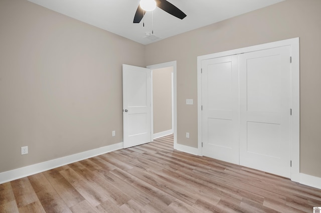 unfurnished bedroom featuring a closet, ceiling fan, and light hardwood / wood-style flooring