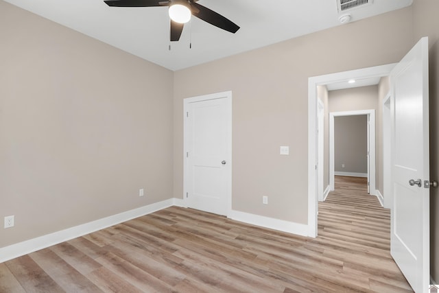 spare room with light hardwood / wood-style floors and ceiling fan