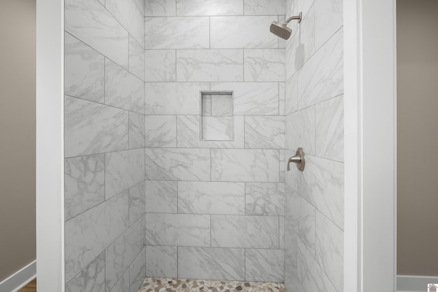 bathroom with tiled shower