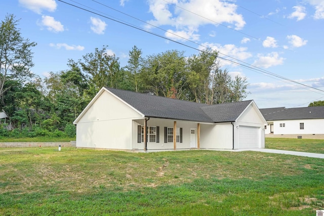 view of front of property with a porch, a front yard, and a garage