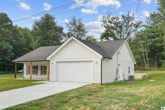 view of front of home with central AC unit, a front lawn, and a garage