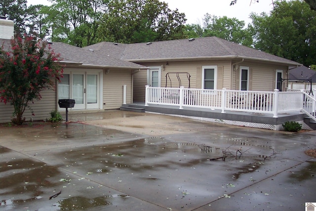 ranch-style house featuring a deck and a patio area