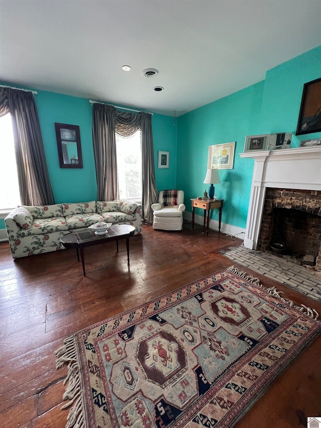 bedroom with dark hardwood / wood-style floors and a fireplace