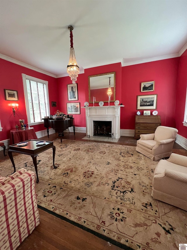 living room with ornamental molding, a notable chandelier, and dark hardwood / wood-style flooring