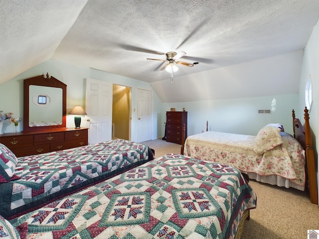 bedroom featuring ceiling fan, a textured ceiling, and light colored carpet