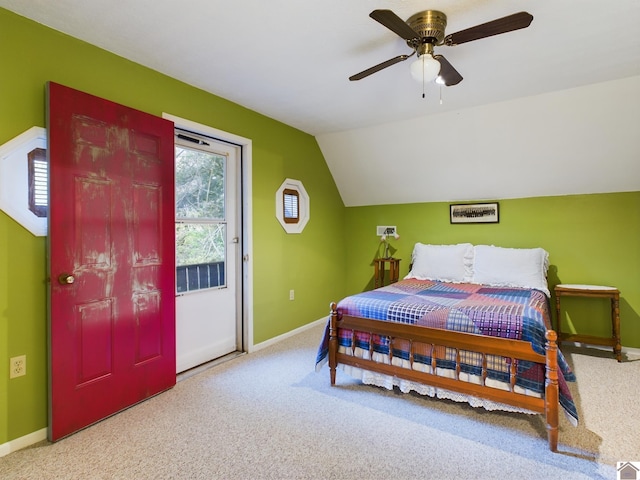 bedroom with vaulted ceiling, light colored carpet, and ceiling fan