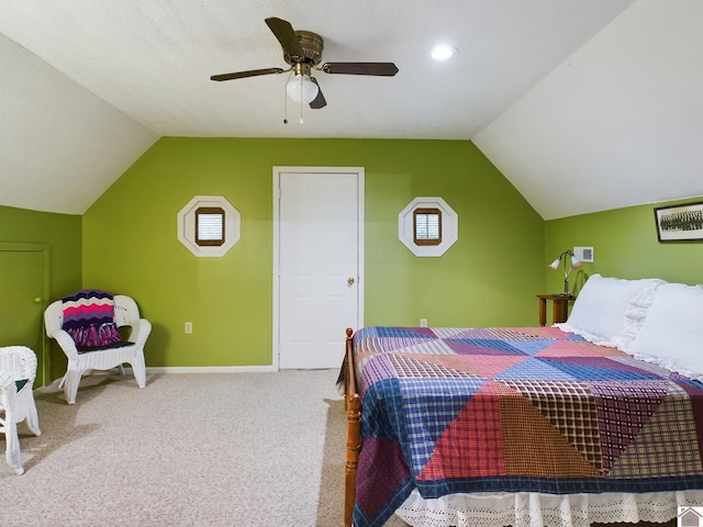 bedroom with light carpet, vaulted ceiling, and ceiling fan