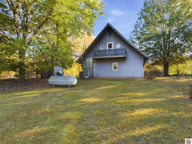 view of property exterior with an outdoor structure and a yard