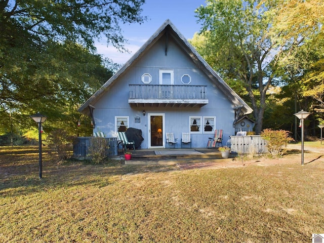 back of property featuring a lawn and french doors