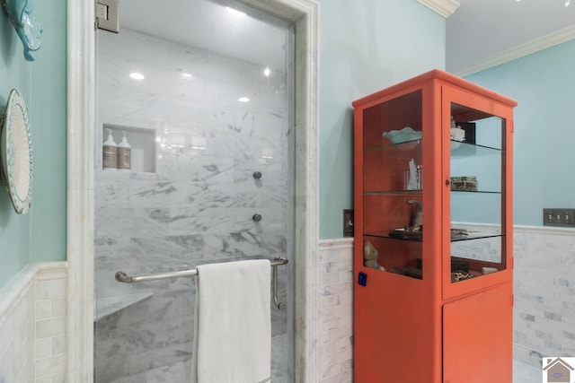 bathroom with ornamental molding, an enclosed shower, and tile walls