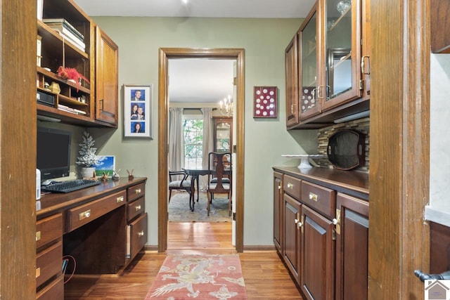 kitchen featuring a notable chandelier and light wood-type flooring