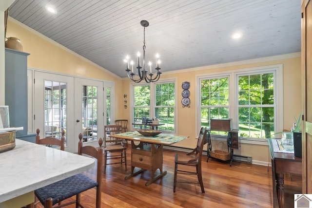 dining area with french doors, ornamental molding, an inviting chandelier, dark hardwood / wood-style flooring, and plenty of natural light