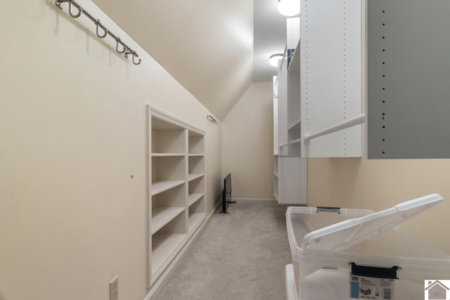 spacious closet featuring light carpet and lofted ceiling