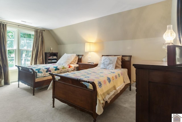 bedroom featuring light carpet and vaulted ceiling