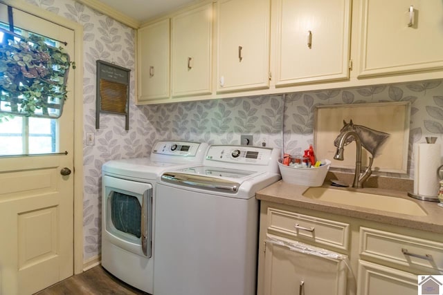 washroom featuring washer and clothes dryer, crown molding, sink, cabinets, and dark wood-type flooring