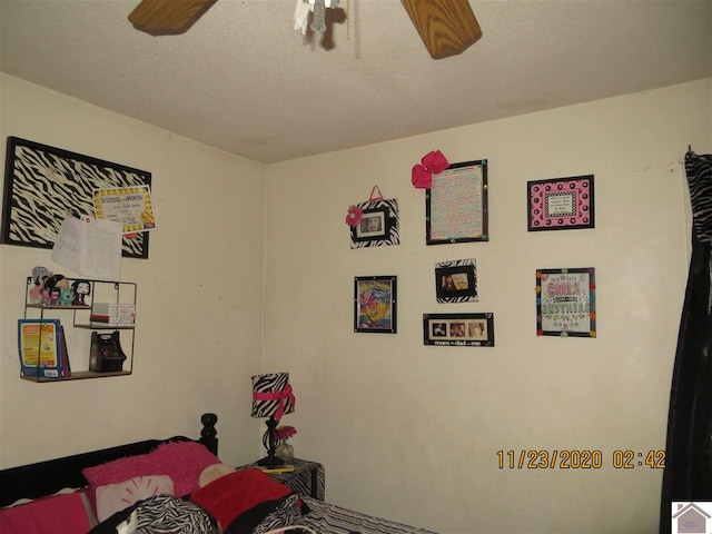 bedroom with a textured ceiling and ceiling fan