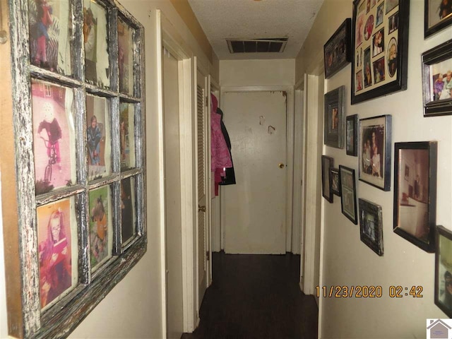 corridor featuring a textured ceiling