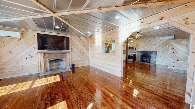 unfurnished living room featuring a brick fireplace, dark wood-type flooring, and wooden walls