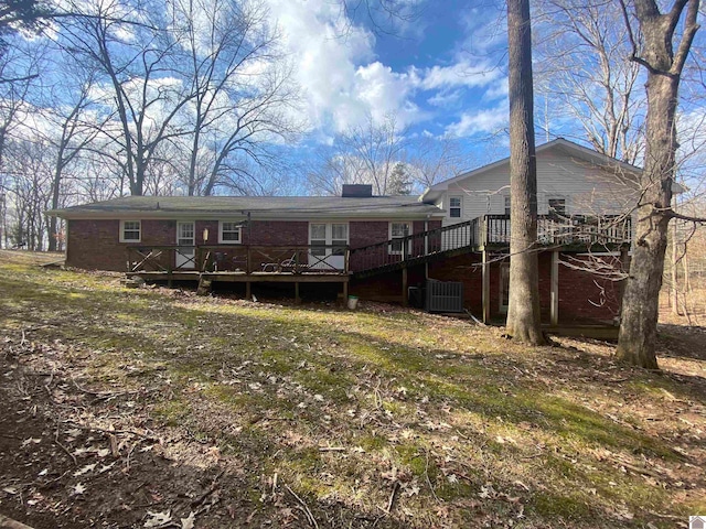 rear view of house featuring a deck