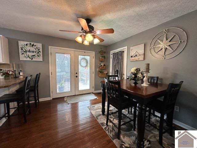 dining room featuring ceiling fan, a textured ceiling, dark hardwood / wood-style floors, and french doors