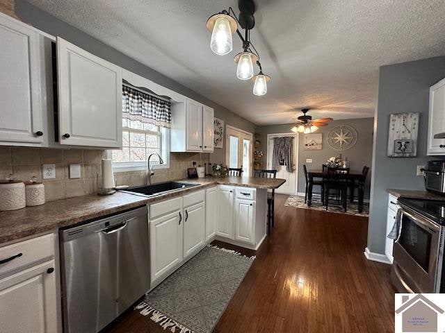 kitchen with ceiling fan, white cabinetry, tasteful backsplash, and stainless steel appliances