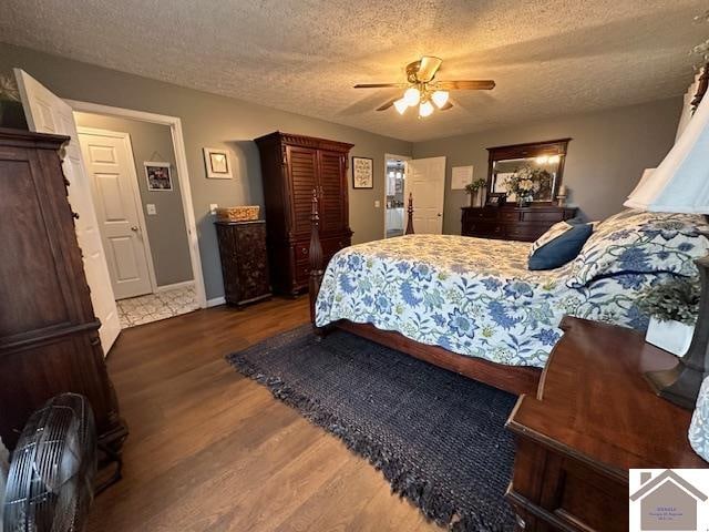 bedroom with dark hardwood / wood-style flooring, a textured ceiling, and ceiling fan