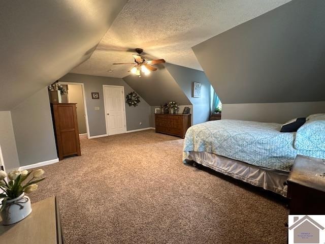 carpeted bedroom with vaulted ceiling, ceiling fan, and a textured ceiling