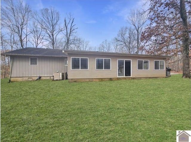 view of front of property featuring central AC and a front lawn