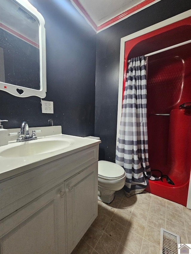 bathroom with toilet, tile floors, ornamental molding, and vanity