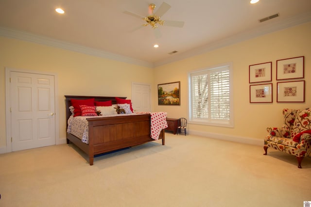 carpeted bedroom featuring ornamental molding and ceiling fan