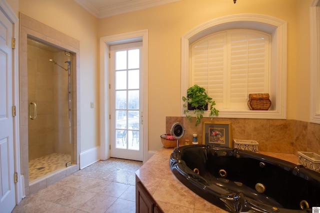 bathroom featuring tile floors, a shower with shower door, a wealth of natural light, and ornamental molding