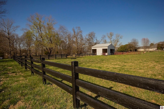 view of yard with a rural view and an outdoor structure