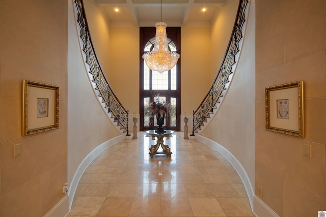 tiled foyer entrance featuring beam ceiling, coffered ceiling, a notable chandelier, and a high ceiling